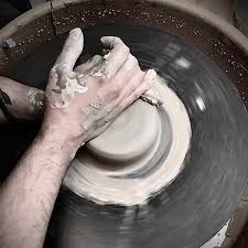 A beginner artist centering clay